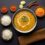 Dal Makhani Recipe: A bowl of dal makhani with rice and spices.