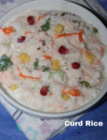 Bowl of curd rice with visible grains, yogurt, carrots, pomegranate seeds, and herbs. Curd Rice Recipe In Hindi.