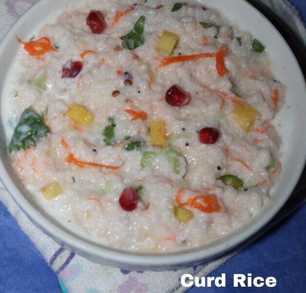 Bowl of curd rice with visible grains, yogurt, carrots, pomegranate seeds, and herbs. Curd Rice Recipe In Hindi.