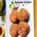 Four paneer cutlet recipe on a white plate with onion and lemon garnish.